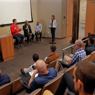 panel of speakers in boardroom
