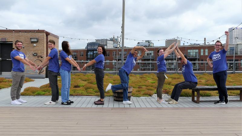 Interns on a green roof. What are they spelling? 