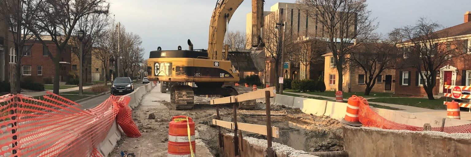 construction crew replacing sanitary sewer in street