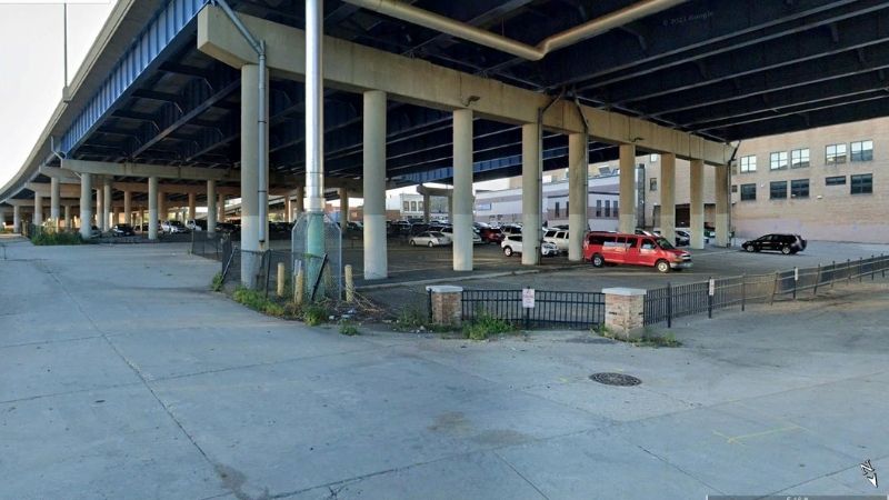 cars parked underneath overpass