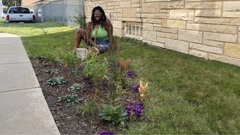 Homeonwer show her rain garden