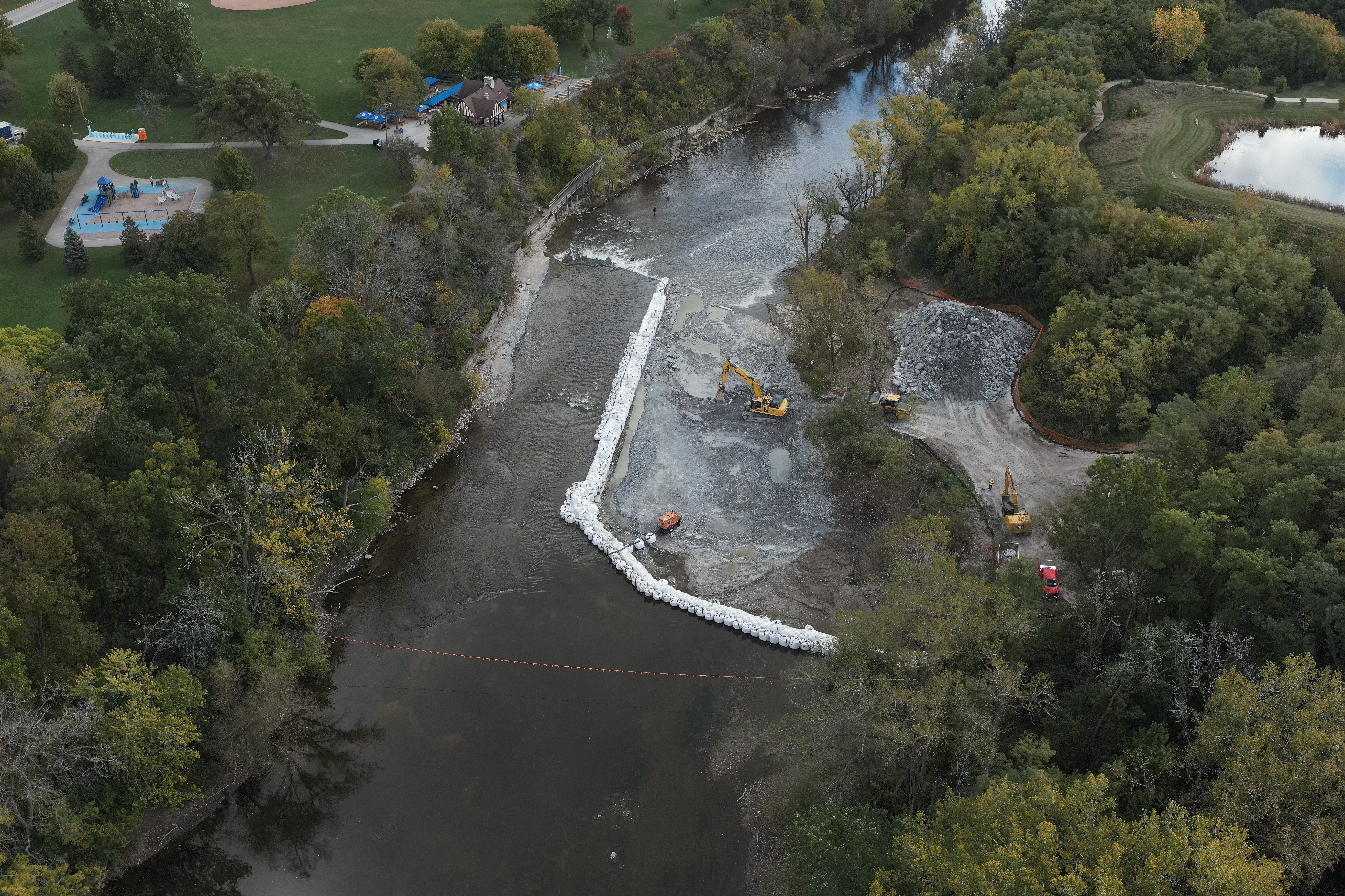 Crews lowering the bedrock to create a gentler ramp for native fish to swim upstream.