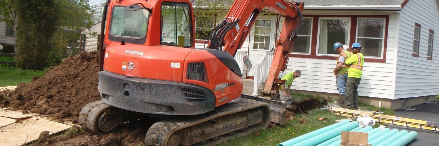 contractors repairing lateral outside of a house