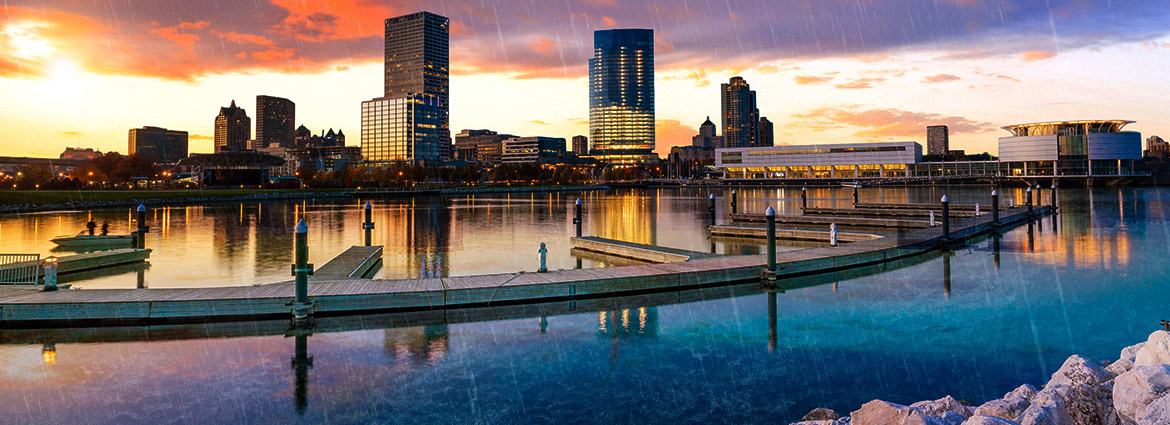 View of Lake Michigan and Milwaukee's skyline at sunset in the rain