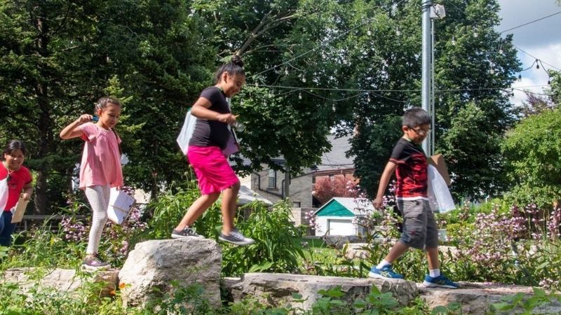 Kids playing in rain garden