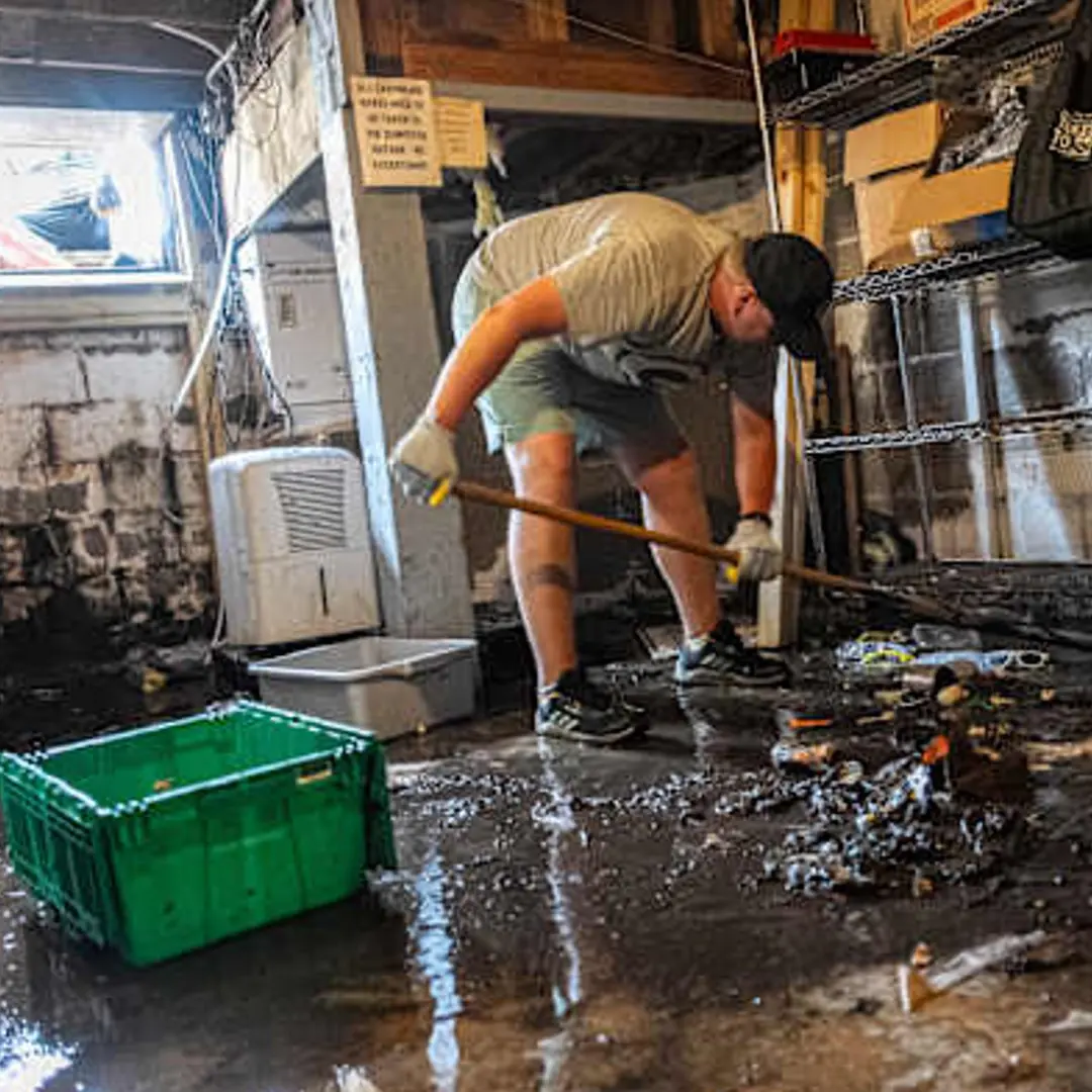 man cleaning out basement form flooding 
