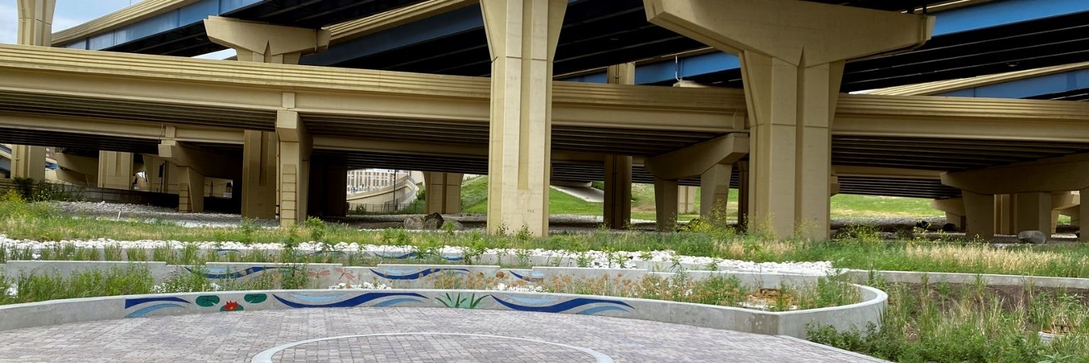 vegetation and porous pavement under an overpass