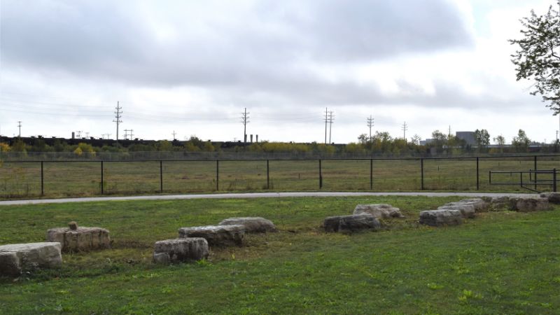 green grass and fencing with boulders